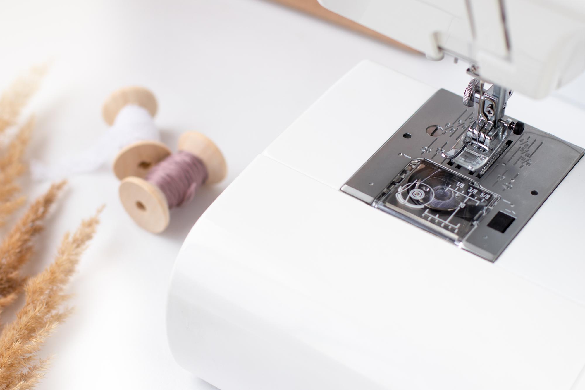sewing machine and embroidered sample on table